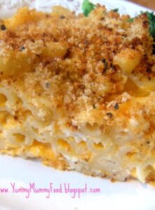 A piece of baked mac and cheese with bread crumb topping.