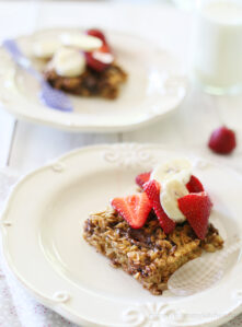 A square of nutella baked oatmeal topped with strawberries.