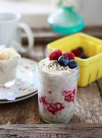 A jar of overnight oatmeal with fresh berries.