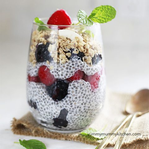 A glass with basic chia pudding, berries, and granola.