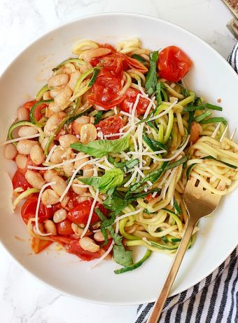 Zucchini noodles with white beans and tomatoes.