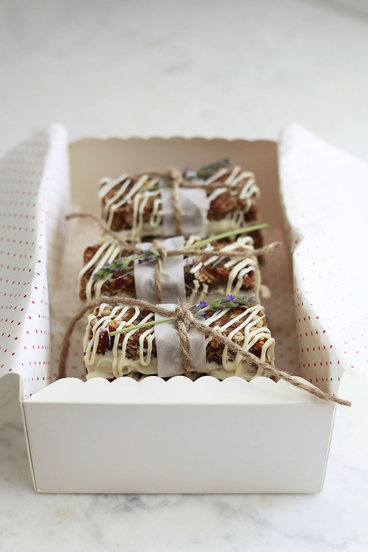 A gift box filled with peanut butter granola bars with cranberries, macadamia nuts, and white chocolate. 