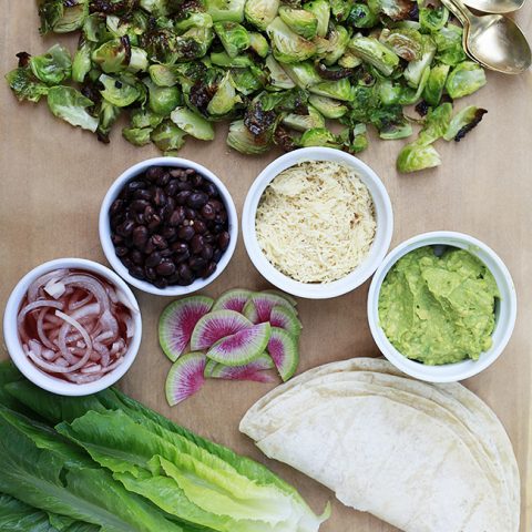 Roasted Brussels sprouts and toppings to make Brussels sprouts tacos.