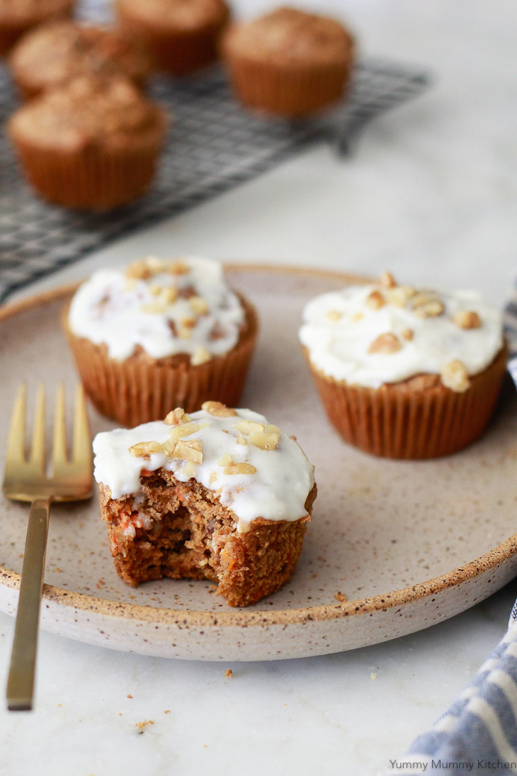 Healthy carrot muffins made with oat flour and topped with a cream cheese frosting. These blender carrot muffins are vegan and gluten free. 
