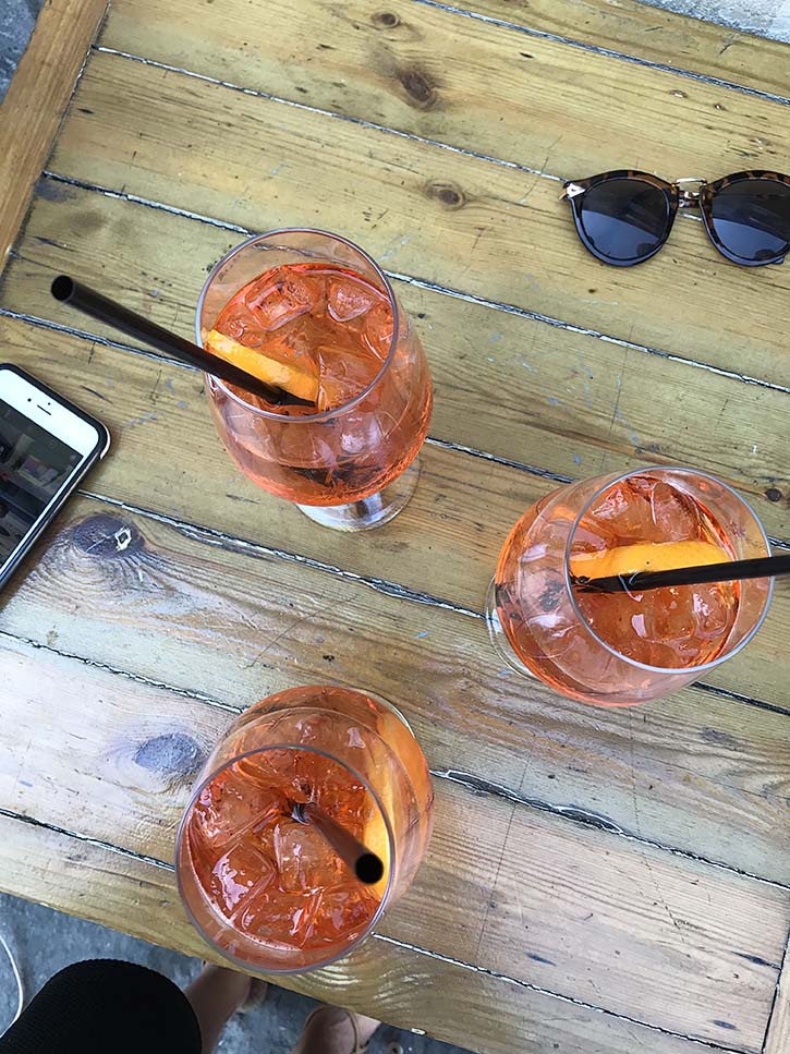 Orange Aperol Spritzes on a table in Florence
