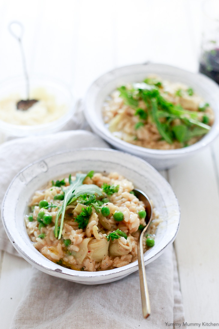 Beautiful rustic bowls of risotto with peas and artichoke hearts. 