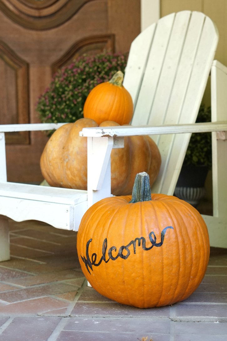 This welcome painted pumpkin is so cute as part of an autumn front porch. 