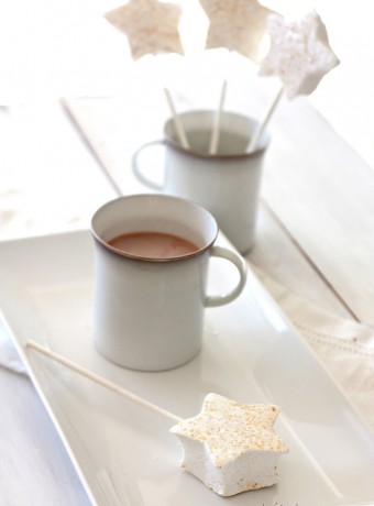Beautiful shimmery start marshmallows on sticks on a white platter and propped up in a white mug.