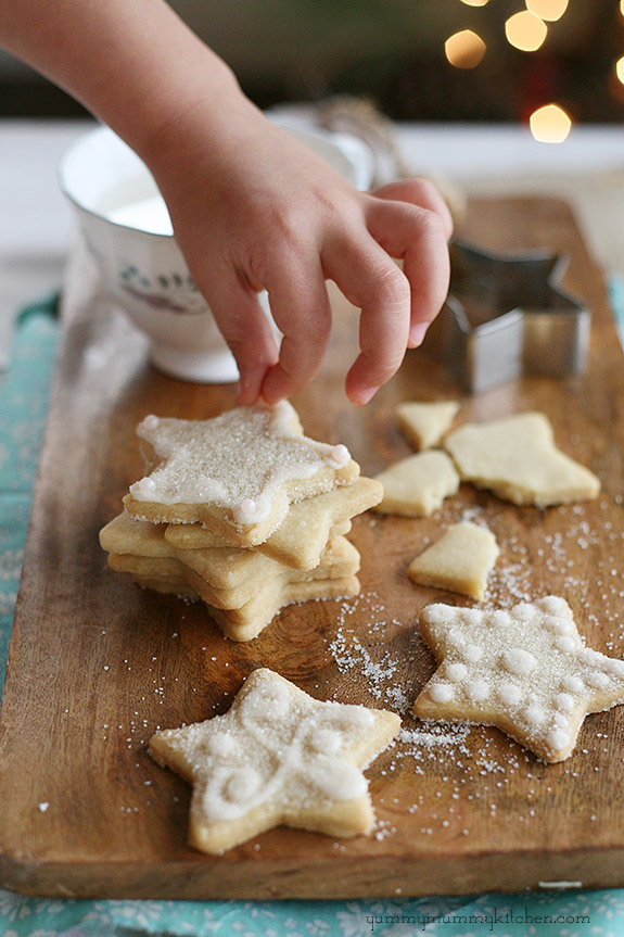 Beautiful vegan sugar cookies topped with white icing and sugar. 