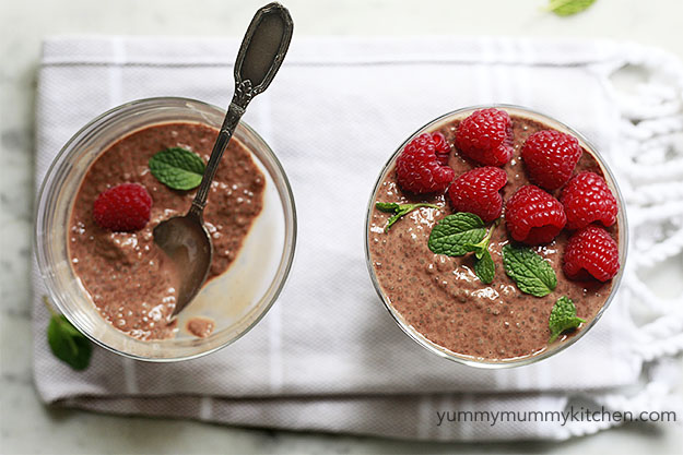 Beautiful bowls of cacao chia pudding with raspberries and mint. 