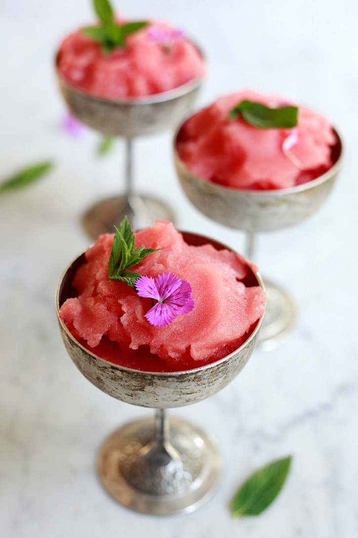 Beautiful glasses of frozen rosé wine slushies with mint