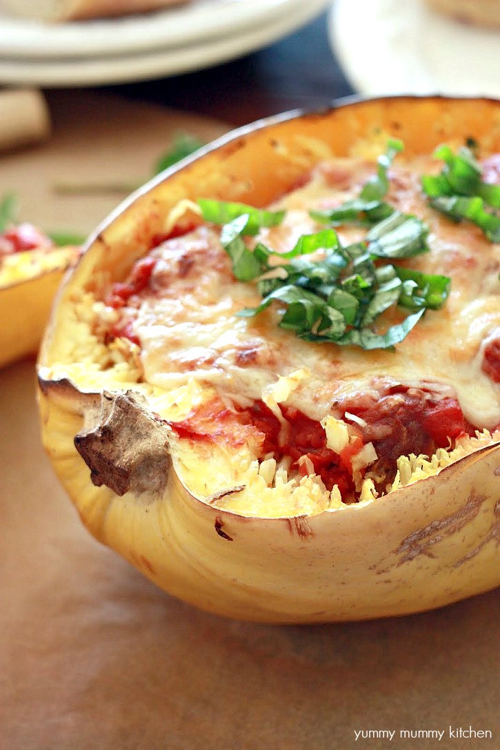 This vegetarian spaghetti squash is stuffed with vegan meatballs, marinara, and topped with cheese.