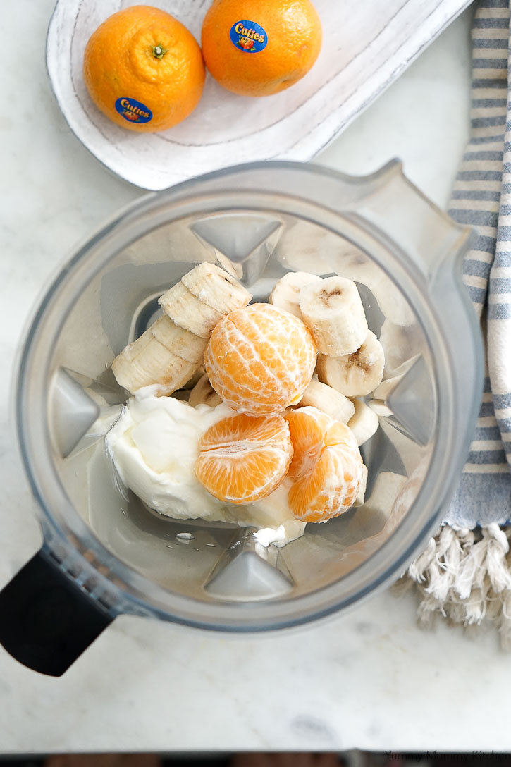 Mandarin oranges, frozen bananas, and yogurt get blended in the Vitamix for a delicious creamy orange smoothie that's vegan and gluten-free friendly.