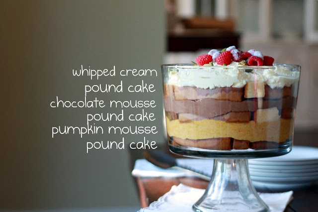 A side view of a trifle layered with pumpkin mousse, chocolate mousse, pound cake, and whipped cream. 