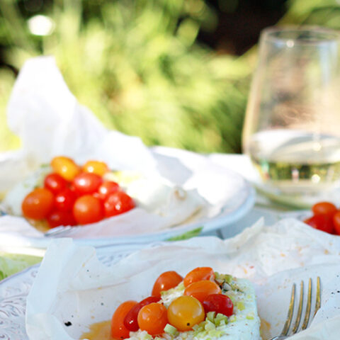 Parchment Papillote packets with halibut, lemongrass and cherry tomatoes.