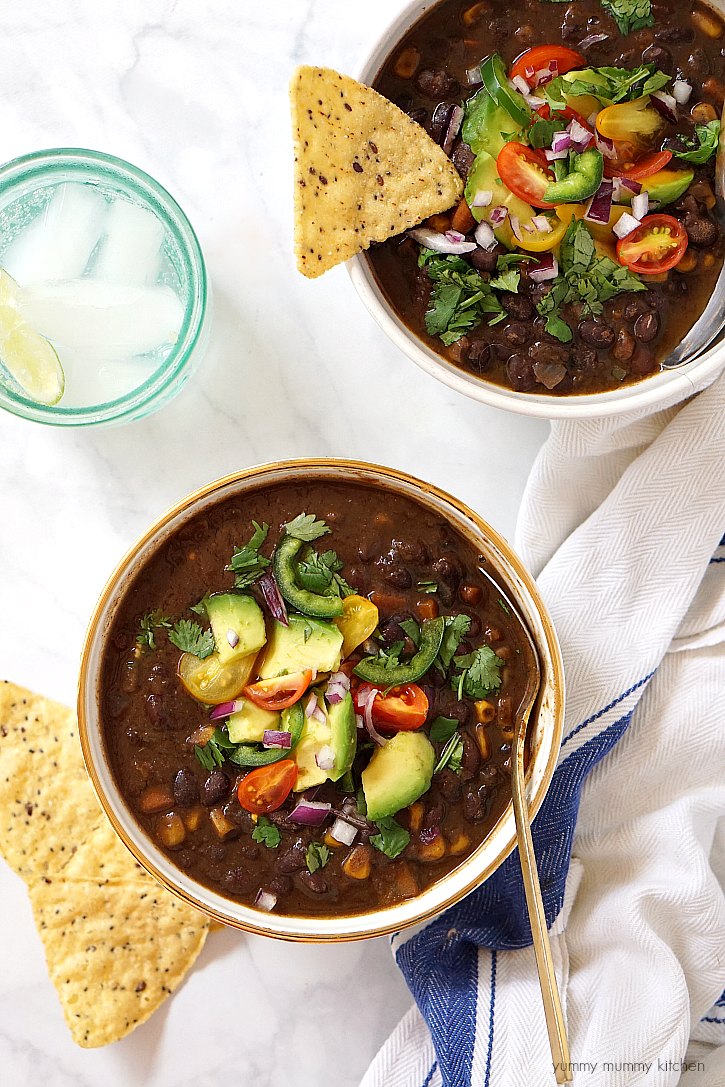 This slow cooker black bean soup is made from scratch with dried black beans, veggies, and spices. Load it up with toppings for a delicious vegetarian and vegan soup! 