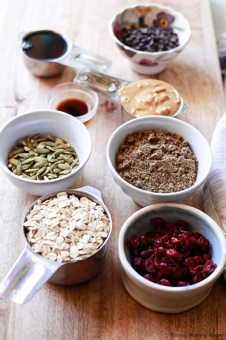 Healthy ingredients like oats, flax, pepitas, and cranberries ready to be made into no-bake energy bars. 