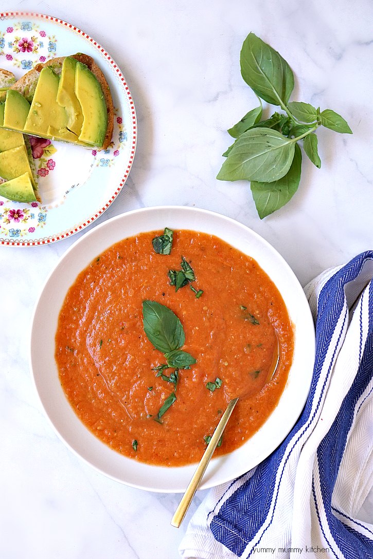 A bowl of tomato soup made from fresh roasted tomatoes and basil makes a delicious light vegan summer meal. 