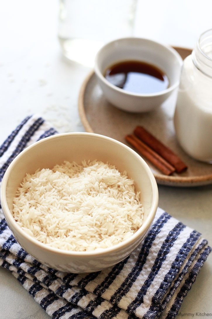 The ingredients for homemade horchata include white rice, maple syrup, cinnamon sticks, and almond milk. 