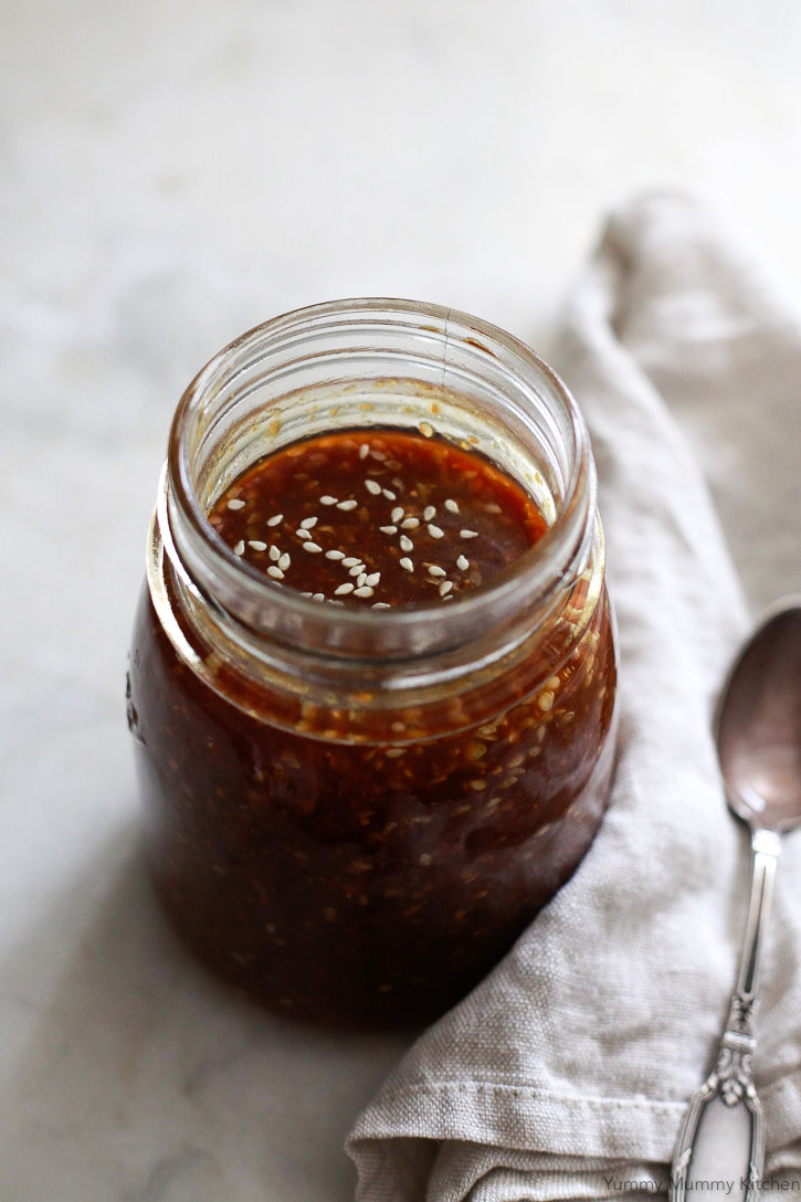 A jar of homemade teriyaki sauce on a white kitchen counter. Find out how to make teriyaki sauce with this easy recipe. It's vegan and gluten free. 