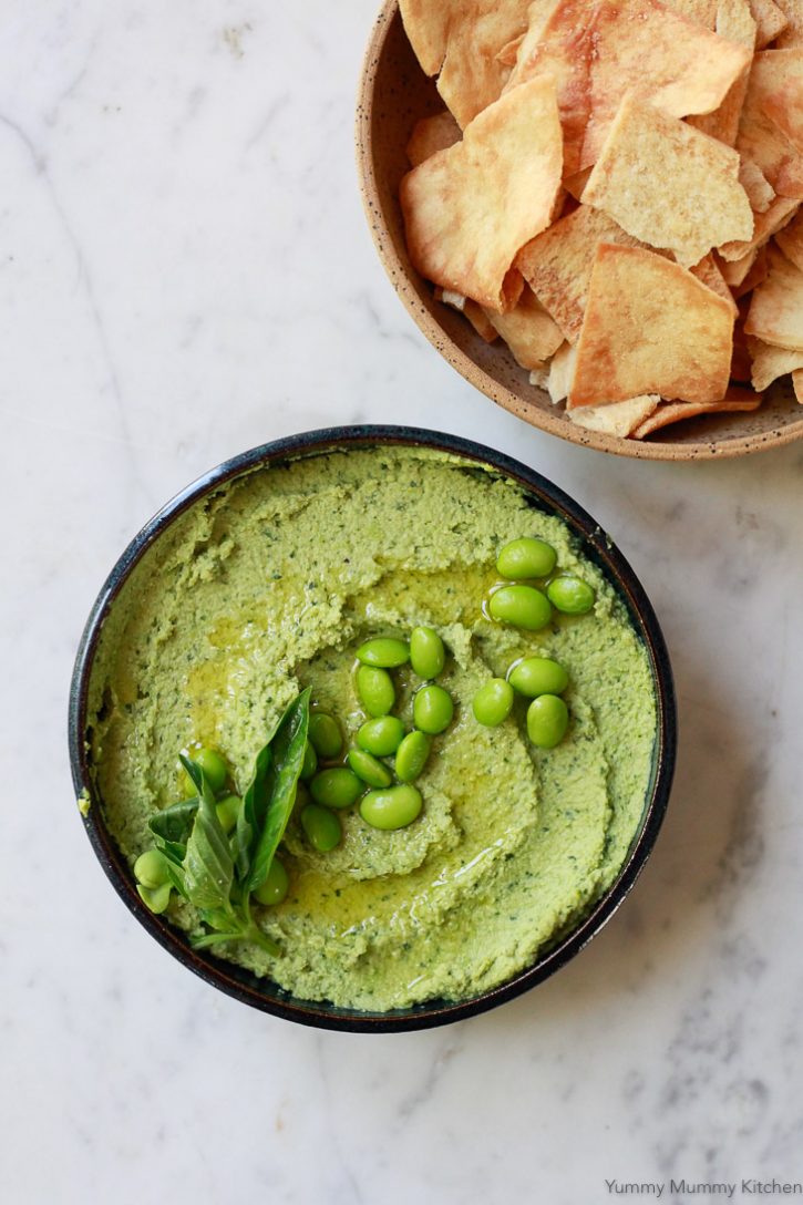 A bowl of homemade vegan edamame basil hummus is the perfect healthy party dip served with crudite veggies or pita chips. 