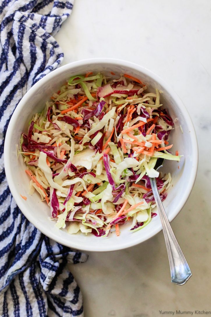 Vegan coleslaw made with shredded green and red cabbage, orange carrots and an easy vegan coleslaw dressing. This creamy classic coleslaw is perfect for summer BBQs or easy weeknight dinners.  