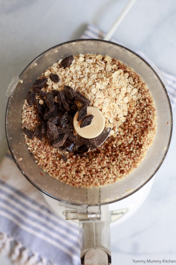 Oats and dark chocolate are added to a food processor to make healthy no-bake oatmeal cookie bites. 