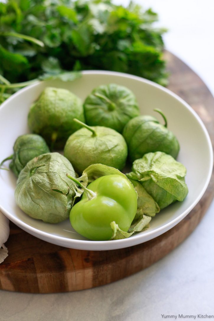 A bowl of fresh tomatillos in their husks are ready to be roasted for tomatillo salsa. 