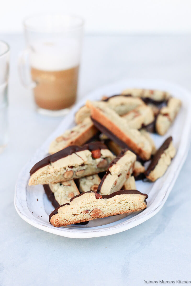 A plate of almond biscotti dipped into chocolate. These healthier biscotti or cantucci are made with almond flour and are gluten free and vegan. 