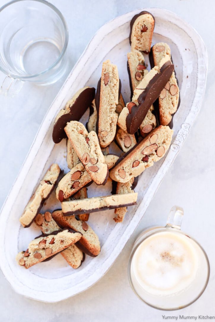 A platter of gluten free almond biscotti dipped in chocolate. 