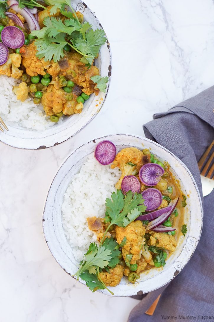 Rice and Gobi Matar Indian coconut curry with cauliflower and peas garnished with fresh cilantro and purple radish. This easy curry recipe is made in the Instant Pot pressure cooker and is vegetarian or vegan and gluten free. 