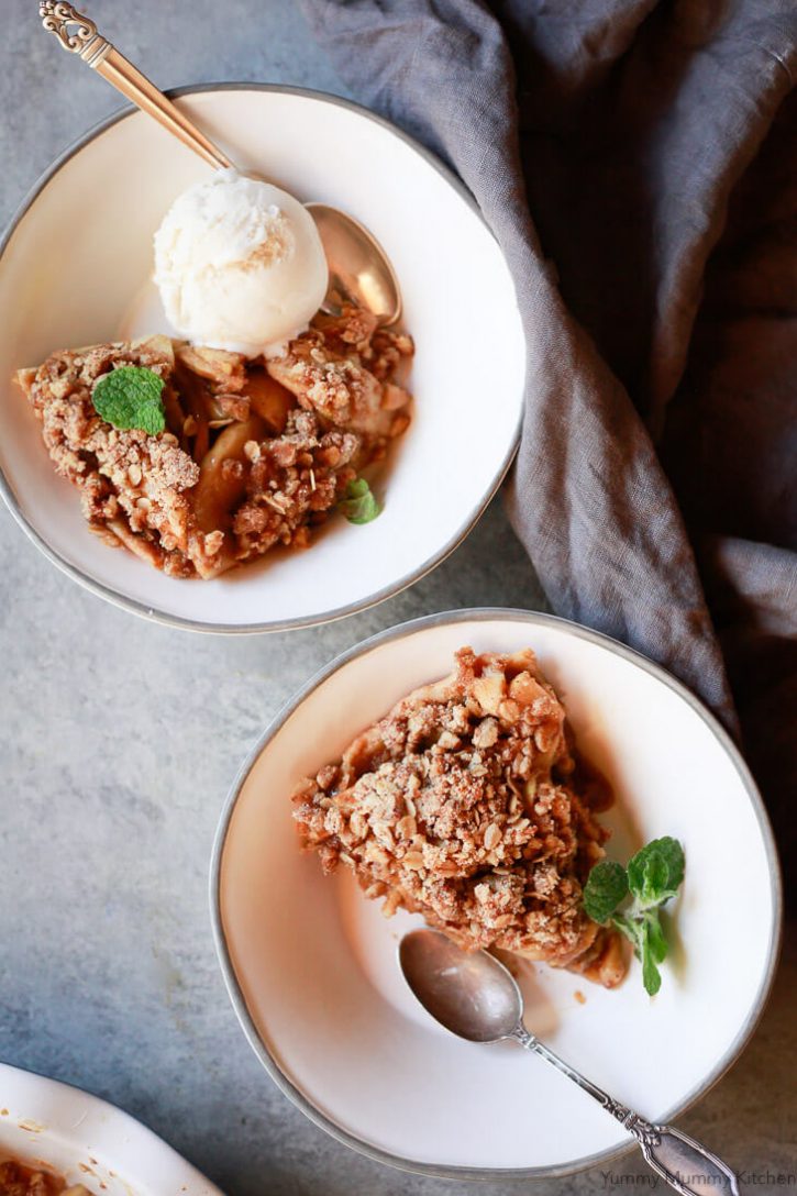 Bowls of apple crumble pie served with ice cream. This easy apple crumble pie is topped with an oatmeal topping and is easy to make vegan and gluten free. 