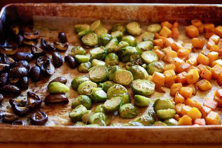 A sheet pan of roasted vegetables: mushrooms, Brussels sprouts, and butternut squash are ready to top Instant pot vegetable risotto. 