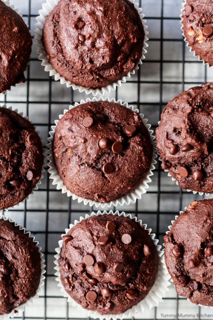 Chocolate banana muffins on a cooling wrack photographed from above. These delicious vegan gluten free chocolate banana muffins are topped with chocolate chips. 