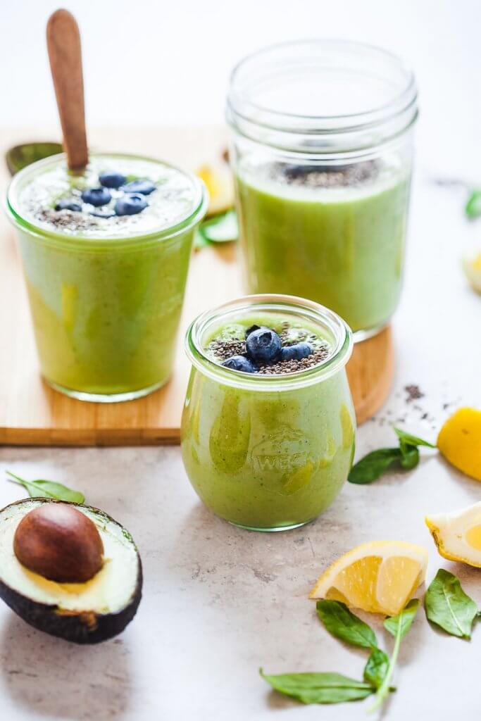 Beautiful green smoothies garnished with blueberries and chia seeds. 