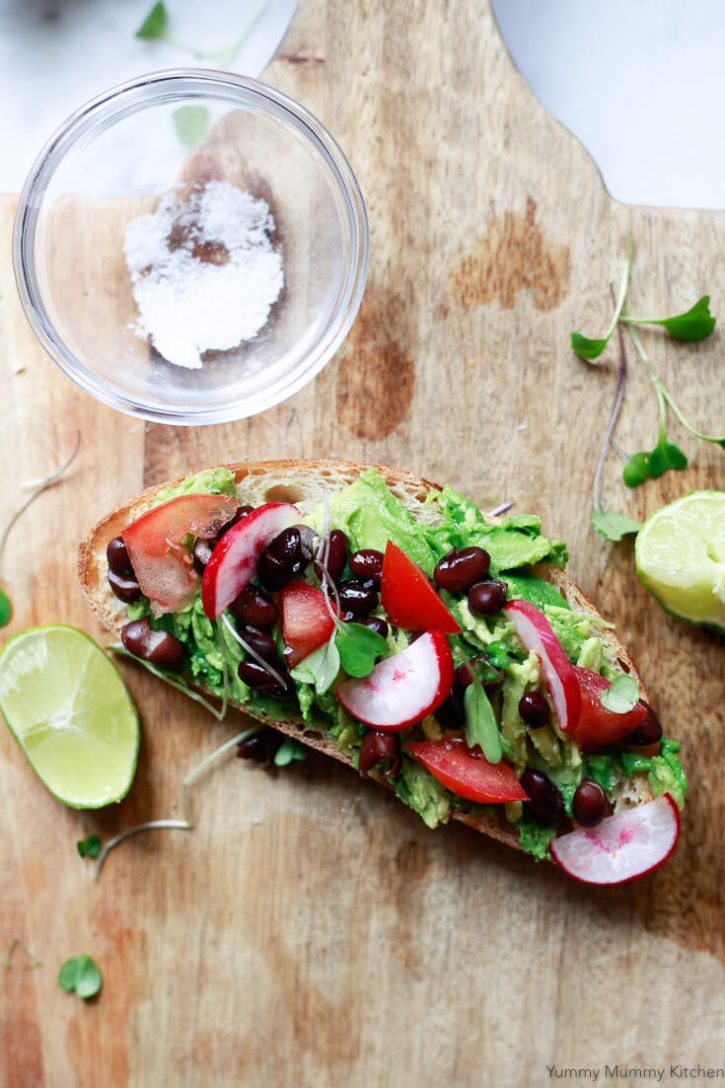 Southwest Mexican inspired Avocado Toast with black beans, lime, tomato, radish, and microgreens. 