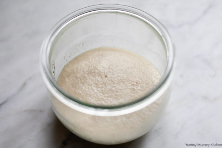 A small glass bowl filled with proofed active dry yeast and water.
