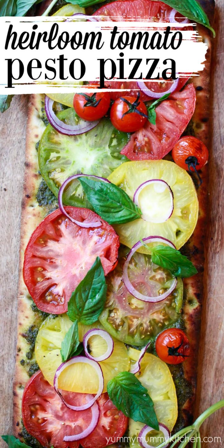 Beautiful cheeseless vegetarian & vegan pizza recipe is topped with heirloom tomatoes, pesto, and basil. Pesto pizza with homemade pizza dough or store bought.