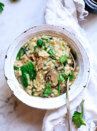 A white bowl filled with mushroom risotto.