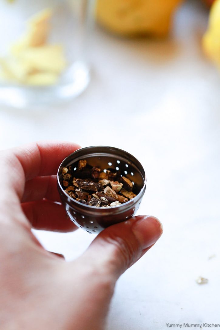 Dried dandelion root in a tea infuser ball. 