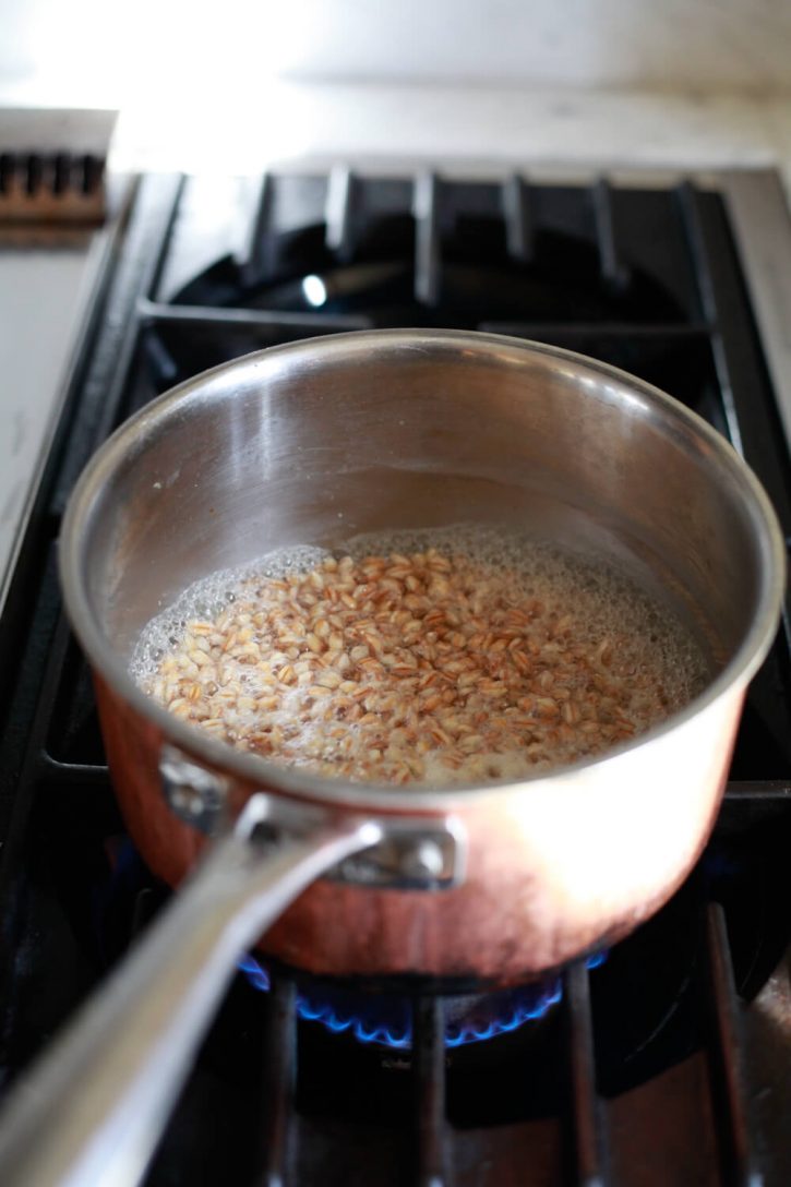 Farro simmers in water on the stove. 
