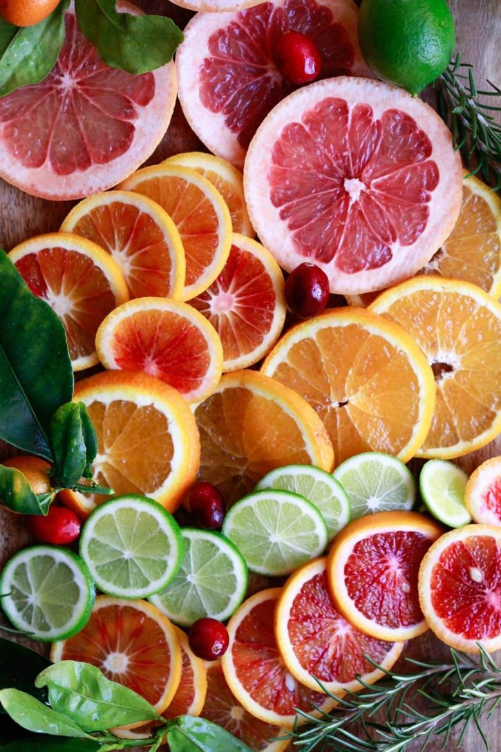 A beautiful photo of sliced citrus for making sangria: grapefruit, blood orange, orange, and lime. 