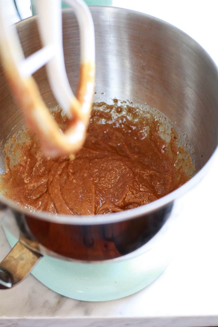 The wet ingredients for vegan peanut butter oat cookies in the bowl of a KitchenAid mixer. 