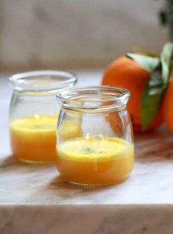 Two small glass jars filled with homemade turmeric wellness shots.