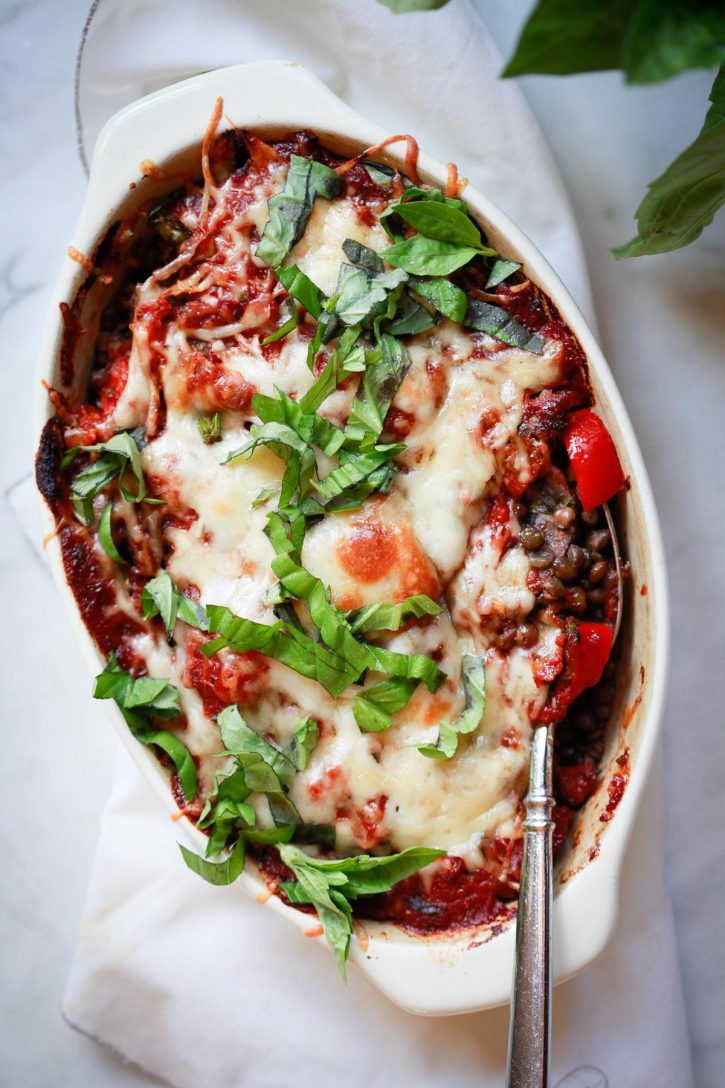 An easy vegetarian casserole recipe with lentils, vegetables, and mozzarella cheese is topped with fresh basil. This delicious lentil bake makes a healthy vegetarian or vegan dinner. 