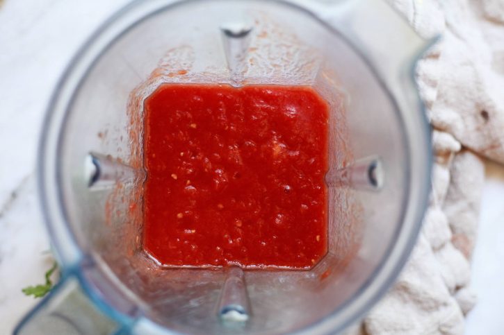 Whole canned tomatoes have been pureed in a blender to make an easy cooked salsa with canned tomatoes. 