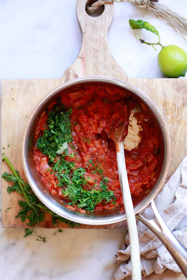 Cilantro is stirred into a homemade cooked salsa roja recipe made with canned tomatoes. 