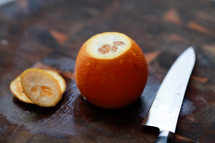 The top and bottom is sliced off an orange. 