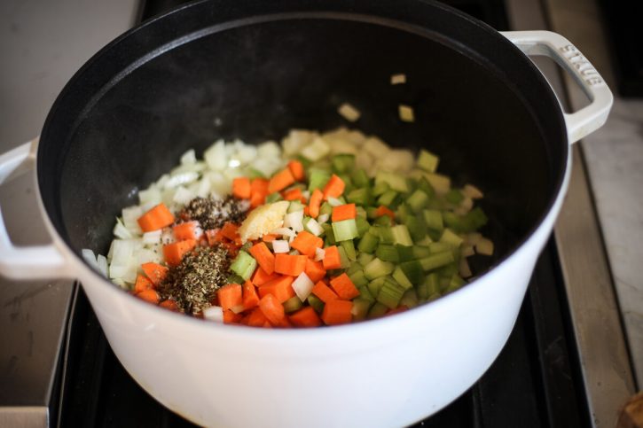 Diced onions, carrots, celery, garlic, salt and pepper in a soup pot to begin making soup. 