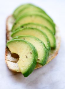 A piece of toast topped with perfectly sliced avocado.